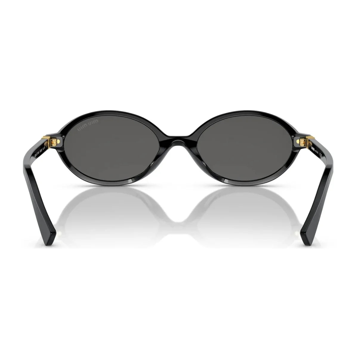 "Stylish woman outdoors in Miu Miu black oval sunglass SMU 04Z, part of the latest Miu Miu eyewear range."