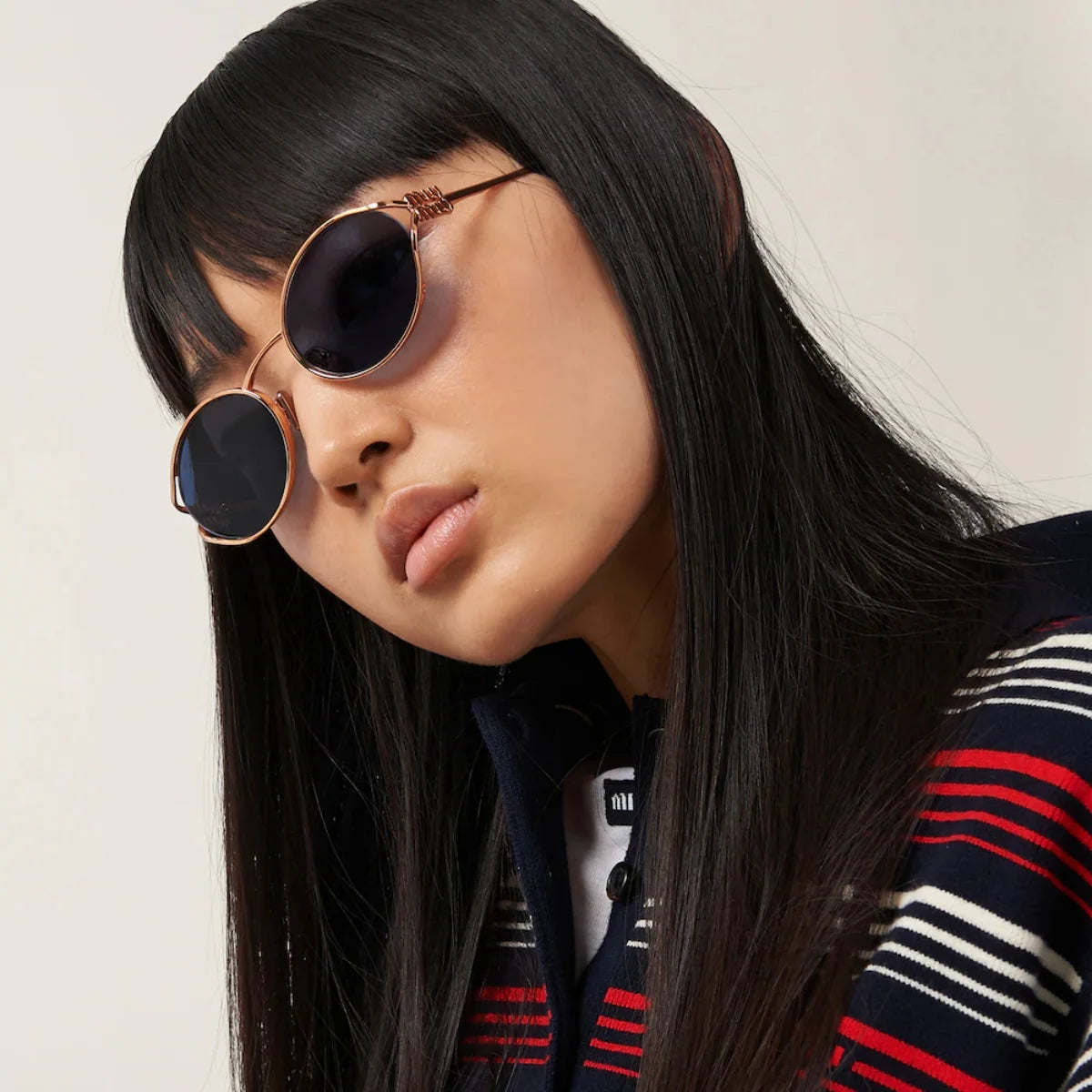 "Rose gold full-frame Miu Miu SMU 52Y ZVF 1V1 women’s sunglasses with dark blue lenses, UV protection, available at Optorium"