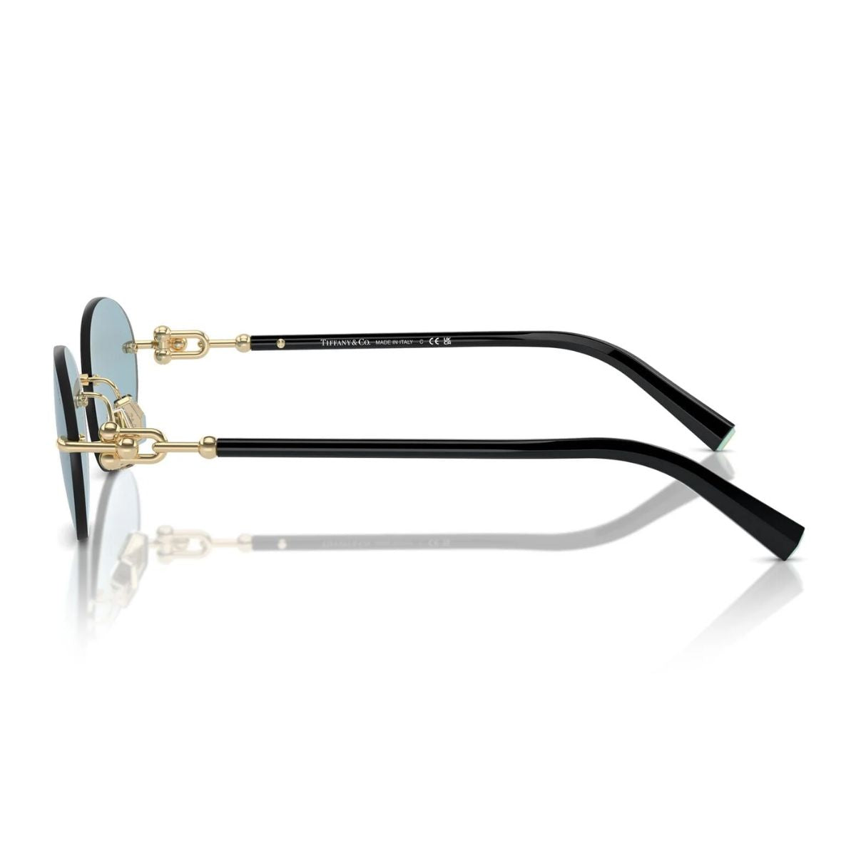 "Elegant woman wearing Tiffany & Co TF 3104-D rimless black/gold sunglasses with blue lenses."